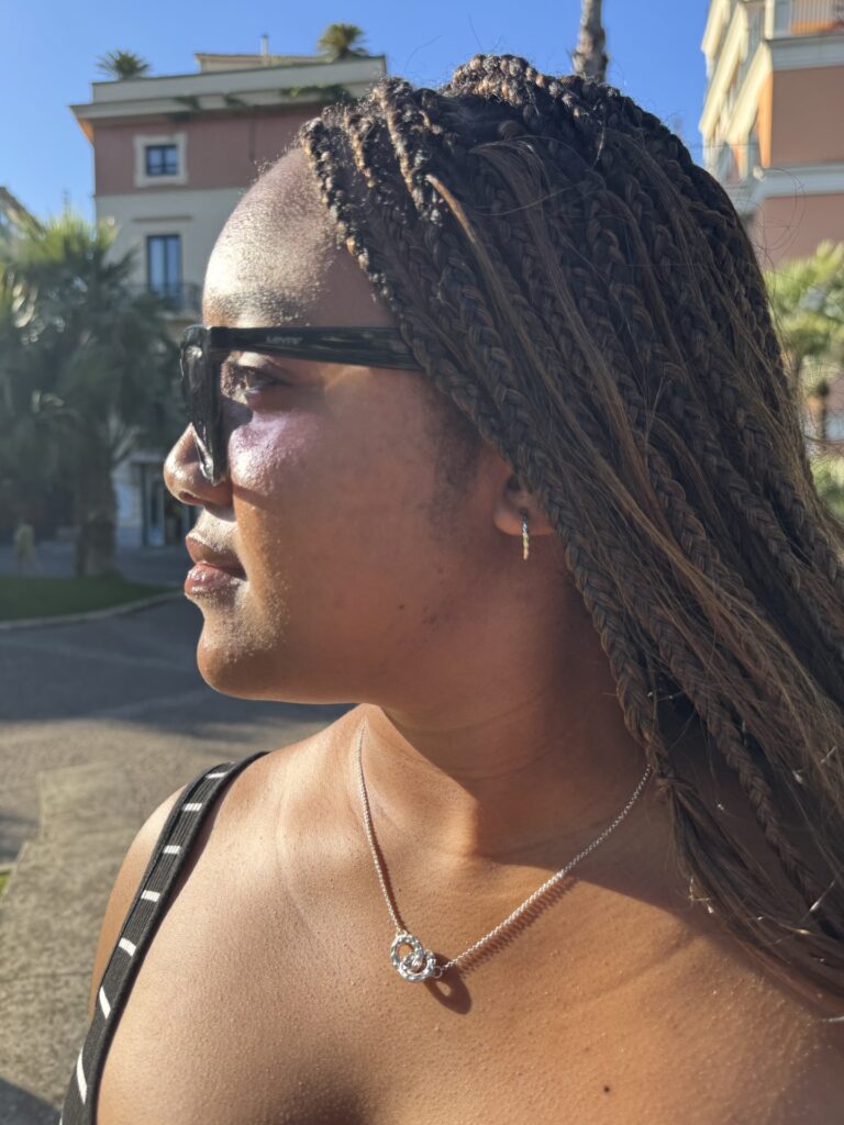 Me wearing sunglasses and turning to look towards the sun.